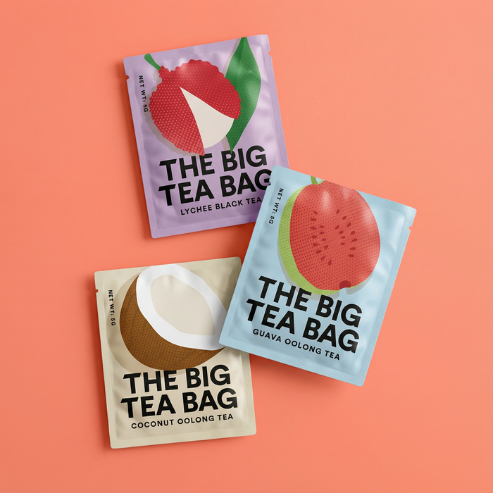 Three 'The Big Tea Bag' tea packages on a peach background